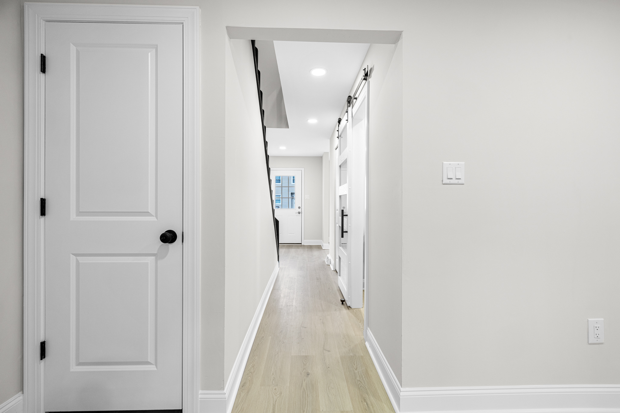 Hallway view highlighting updated trim and flooring