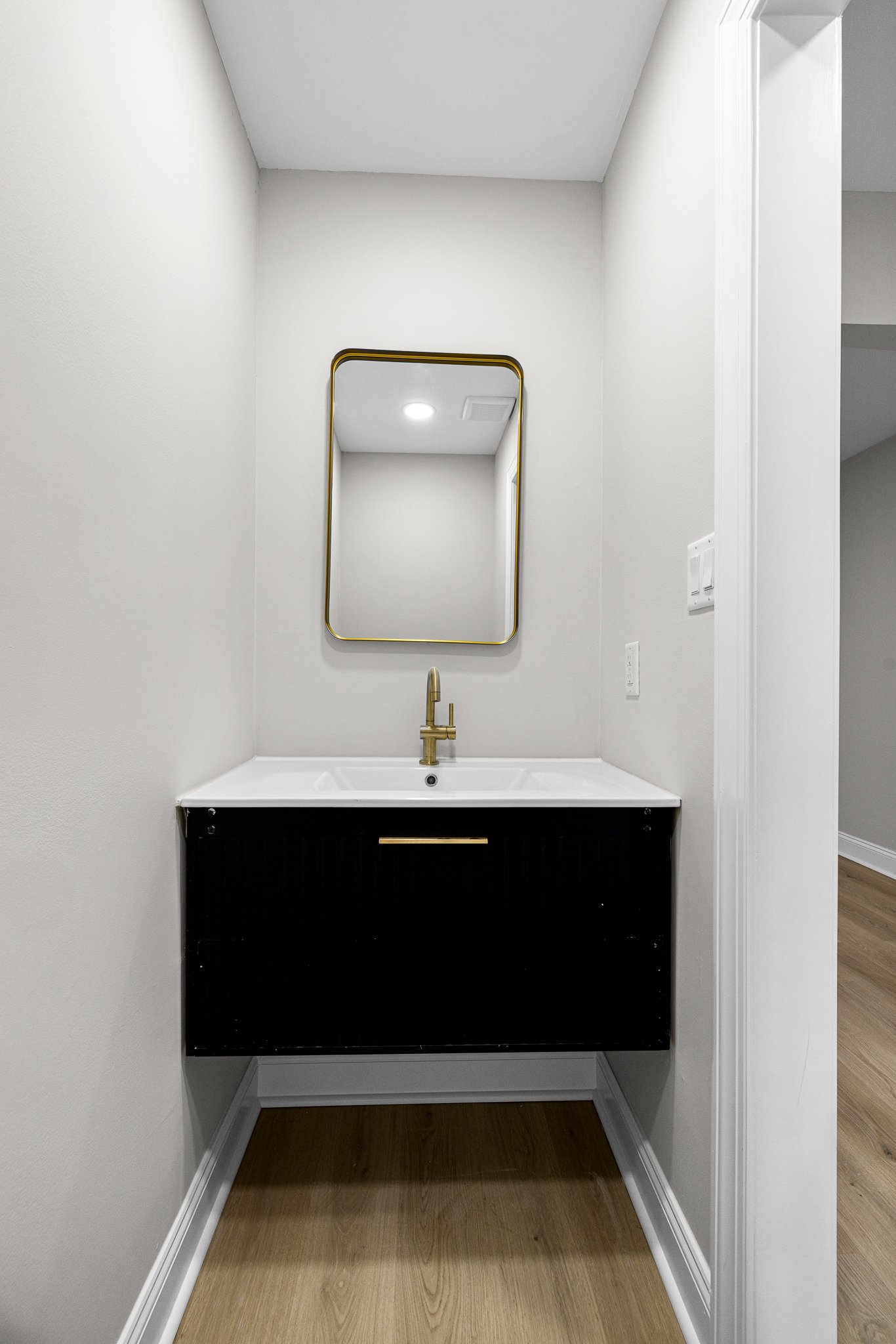 Powder room vanity with modern fixtures