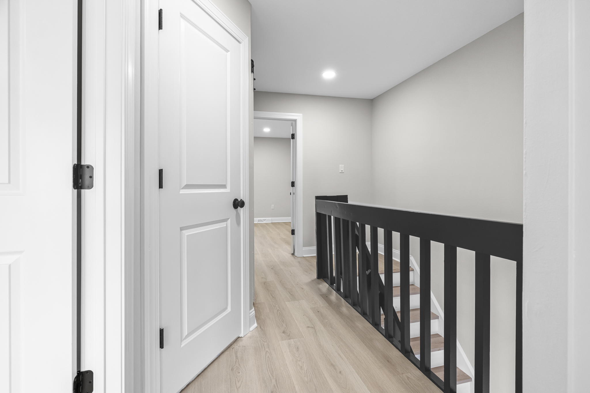 Upper-level landing with new flooring and railing
