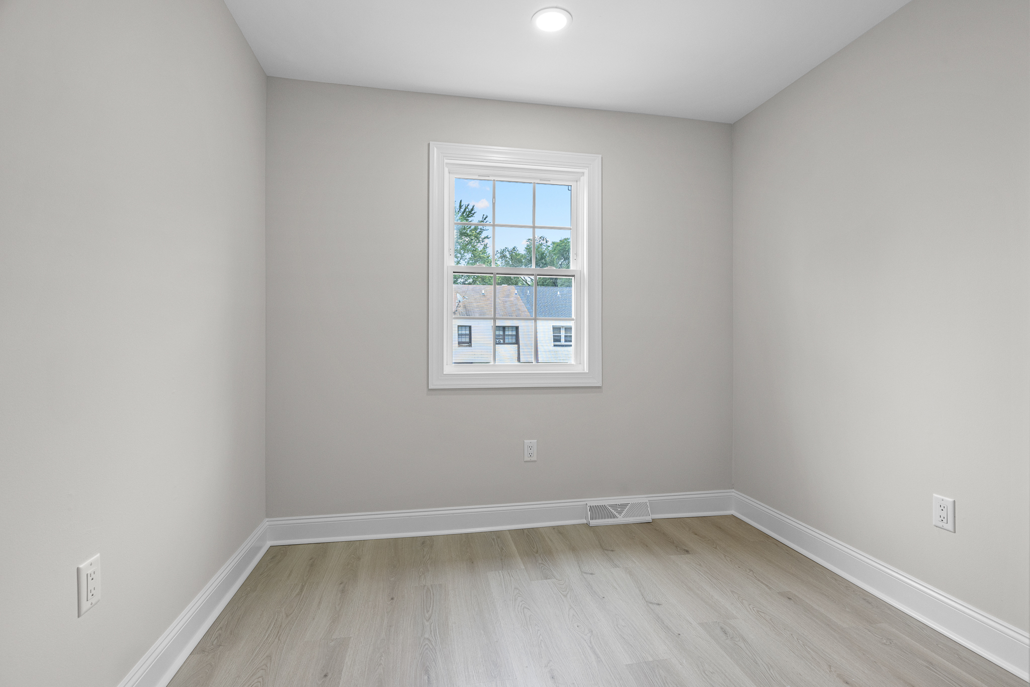 Renovated bedroom with large window
