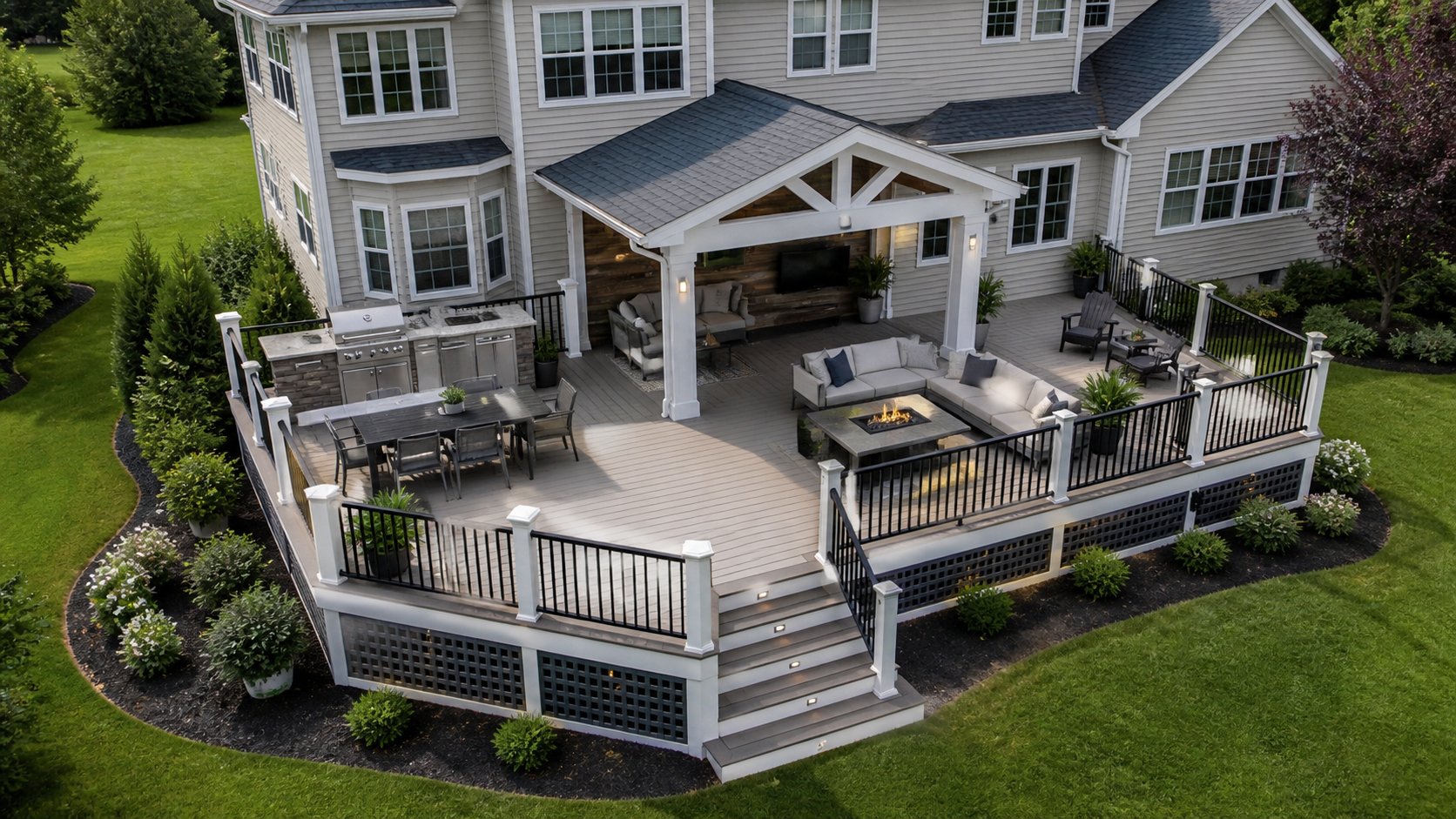 Large custom backyard deck with covered seating area