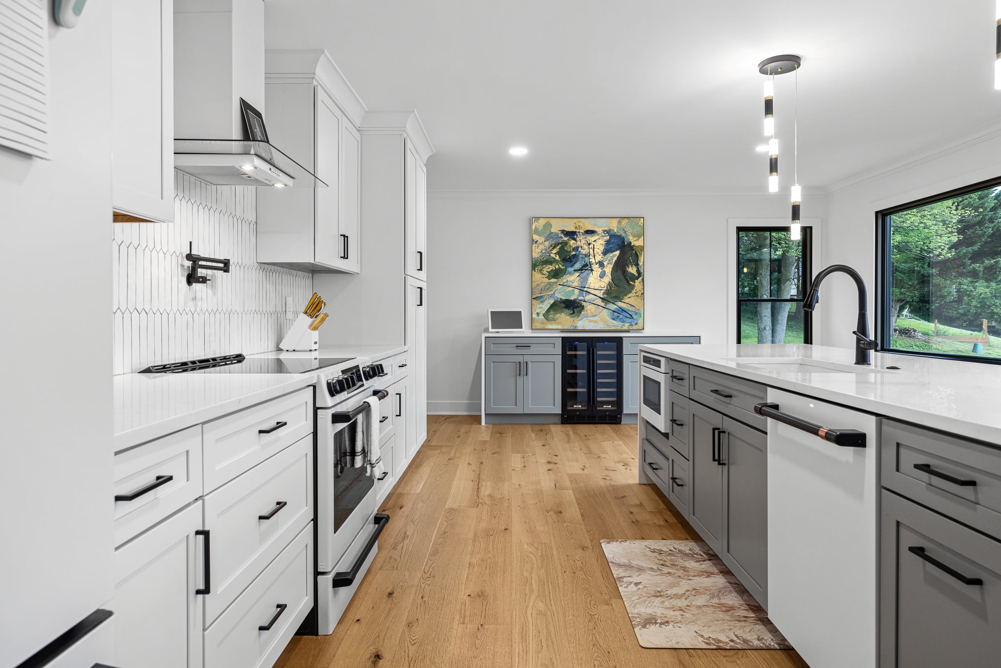 Bright white and gray kitchen with waterfall island