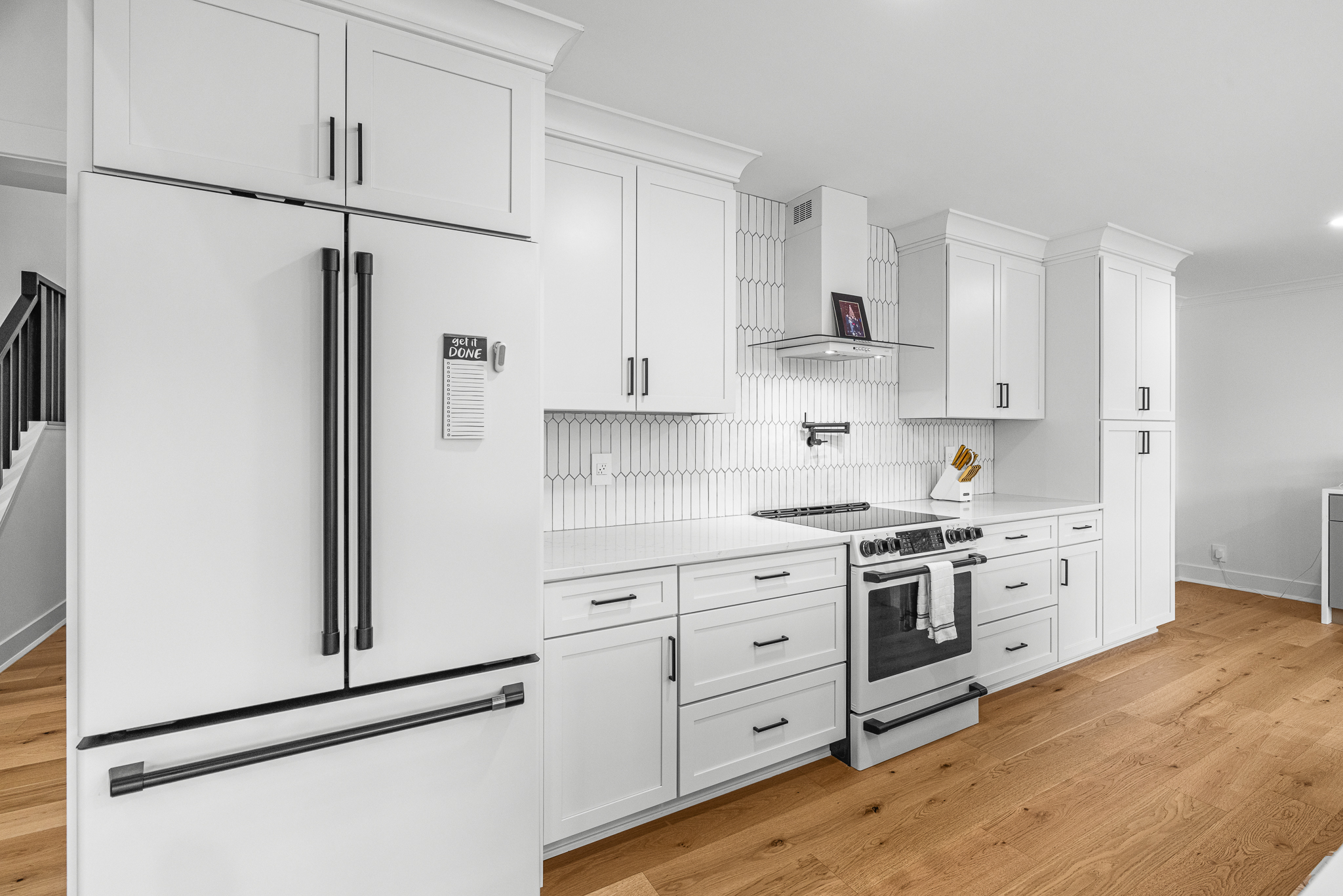White kitchen cabinetry with black hardware